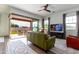 Comfortable living room with green couch and access to backyard at 19087 E Walnut Ct, Queen Creek, AZ 85142
