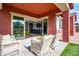 Covered patio offers comfortable seating and views of the kitchen and backyard at 19087 E Walnut Ct, Queen Creek, AZ 85142