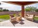 Relaxing patio with wicker furniture and a view of the backyard at 19087 E Walnut Ct, Queen Creek, AZ 85142