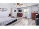 Main bedroom with laminate wood floors and ensuite bathroom at 23735 W Wayland Dr, Buckeye, AZ 85326