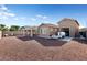 Large backyard with gravel landscaping, a covered patio, and a detached garage at 24211 N 168Th Ln, Surprise, AZ 85387