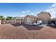Spacious backyard with gravel, a covered patio, and detached garage at 24211 N 168Th Ln, Surprise, AZ 85387