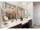 Double vanity bathroom with large mirrors and a walk-in shower at 24211 N 168Th Ln, Surprise, AZ 85387