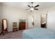 Spacious bedroom with ceiling fan, dresser, and ensuite bathroom at 24211 N 168Th Ln, Surprise, AZ 85387