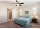 Bright bedroom with ceiling fan and sliding barn door to ensuite bath at 24211 N 168Th Ln, Surprise, AZ 85387