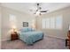 Main bedroom with a ceiling fan, large windows, and plush carpeting at 24211 N 168Th Ln, Surprise, AZ 85387