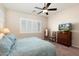 Comfortable bedroom with ceiling fan and large window at 24211 N 168Th Ln, Surprise, AZ 85387