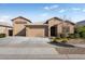 Single-story home with two-car garage and landscaped front yard at 24211 N 168Th Ln, Surprise, AZ 85387