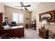 Home office with a large desk, chair, and built-in shelving at 24211 N 168Th Ln, Surprise, AZ 85387