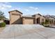 Two-story house with a three-car garage and drought-tolerant landscaping at 24211 N 168Th Ln, Surprise, AZ 85387
