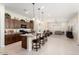 Kitchen boasts an island with seating, granite counters, and ample cabinetry at 24211 N 168Th Ln, Surprise, AZ 85387