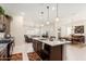 Open kitchen with large island and views into living and dining areas at 24211 N 168Th Ln, Surprise, AZ 85387