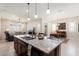 Island kitchen features granite countertops, stainless steel appliances, and a breakfast bar at 24211 N 168Th Ln, Surprise, AZ 85387