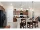 Modern kitchen with granite countertops and dark wood cabinets at 24211 N 168Th Ln, Surprise, AZ 85387