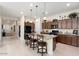Open concept kitchen with granite countertops and dark wood cabinets at 24211 N 168Th Ln, Surprise, AZ 85387