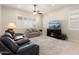 Bright living room with comfortable seating, a large TV, and lots of natural light at 24211 N 168Th Ln, Surprise, AZ 85387