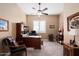 Home office with a large desk, comfortable chair and built-in shelving at 24211 N 168Th Ln, Surprise, AZ 85387