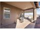 Outdoor kitchen and dining area on the covered patio at 24211 N 168Th Ln, Surprise, AZ 85387