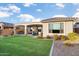 Backyard with covered patio, artificial turf and landscaping at 27453 W Wahalla Ln, Buckeye, AZ 85396