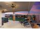 Evening view of covered patio with mountain views and lush lawn at 27453 W Wahalla Ln, Buckeye, AZ 85396