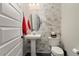 Bathroom with pedestal sink and marble tile at 27453 W Wahalla Ln, Buckeye, AZ 85396