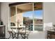 Small breakfast nook with table and chairs overlooking the backyard at 27453 W Wahalla Ln, Buckeye, AZ 85396
