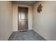 Front entry with dark brown door and tile flooring at 27453 W Wahalla Ln, Buckeye, AZ 85396