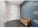 Bright entryway with white door and a wooden bench at 27453 W Wahalla Ln, Buckeye, AZ 85396