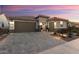 Single story home with a brown garage door and landscaped front yard at 27453 W Wahalla Ln, Buckeye, AZ 85396