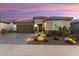 Single-story home with brown garage door and landscaped yard at 27453 W Wahalla Ln, Buckeye, AZ 85396