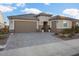 Single-story house with brown garage door and well-maintained landscaping at 27453 W Wahalla Ln, Buckeye, AZ 85396