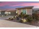 Landscaped front yard with drought-tolerant plants and a paved driveway at 27453 W Wahalla Ln, Buckeye, AZ 85396