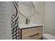 Stylish bathroom with a vanity, a large mirror, and a black and white geometric shower curtain at 2937 E Osborn Rd, Phoenix, AZ 85016