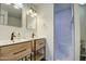 Renovated bathroom featuring double sinks, stylish vanity, and a shower with a built-in seat at 2937 E Osborn Rd, Phoenix, AZ 85016