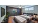 Spacious bedroom with a comfortable bed, dark brick accent wall, and plenty of natural light at 2937 E Osborn Rd, Phoenix, AZ 85016
