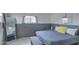 Cozy bedroom with gray bedding and a full-length mirror at 2937 E Osborn Rd, Phoenix, AZ 85016