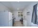 Small kitchen with white appliances and open shelving at 2937 E Osborn Rd, Phoenix, AZ 85016
