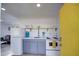 Small galley kitchen with white cabinets and appliances at 2937 E Osborn Rd, Phoenix, AZ 85016