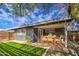 Covered patio with a dining table and chairs, artificial turf, and modern fence at 2937 E Osborn Rd, Phoenix, AZ 85016
