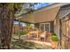 Covered patio with dining set, artificial turf, and modern wood fence at 2937 E Osborn Rd, Phoenix, AZ 85016