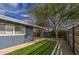 Side yard with artificial turf and modern wood fence at 2937 E Osborn Rd, Phoenix, AZ 85016