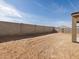 Empty backyard with concrete block fence on a sunny day at 37073 W La Paz St, Maricopa, AZ 85138