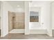Modern bathroom with tile shower, separate tub, and natural light at 37073 W La Paz St, Maricopa, AZ 85138