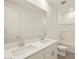 Bathroom featuring double sinks, a large mirror, and a shower-tub combination at 37073 W La Paz St, Maricopa, AZ 85138