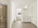 Open bathroom view featuring a walk-in shower, tub and vanity with tile flooring at 37073 W La Paz St, Maricopa, AZ 85138