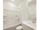 Clean white bathroom featuring a bathtub with shower head, modern sink and toilet at 37073 W La Paz St, Maricopa, AZ 85138