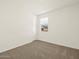 Bright bedroom features neutral carpet, a window with blinds, and fresh, clean walls at 37073 W La Paz St, Maricopa, AZ 85138