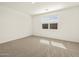 Bright bedroom with neutral carpet and a sunlit window at 37073 W La Paz St, Maricopa, AZ 85138