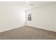 Bright bedroom features neutral carpet, a window with blinds, and fresh, clean walls at 37073 W La Paz St, Maricopa, AZ 85138