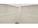 Walk-in closet with white walls, carpet, and ample hanging storage space with metal racks at 37073 W La Paz St, Maricopa, AZ 85138